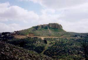 Iraq Burin village dominates the sky line on top of the natural rock outcrop as we walked in along the road from Tell.